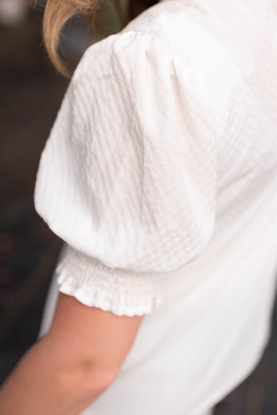 Close up of the sleeve on the off white puff sleeve top.
