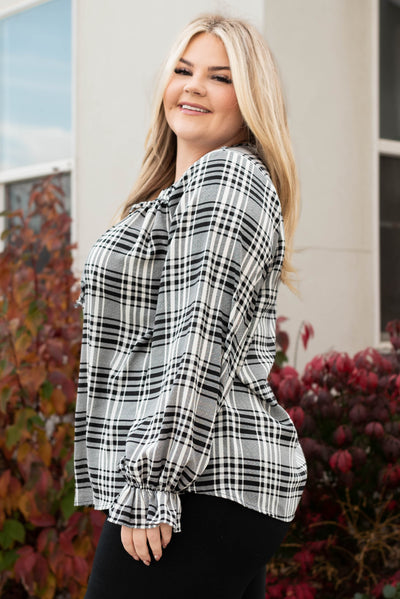Side view of the plus size black plaid blouse