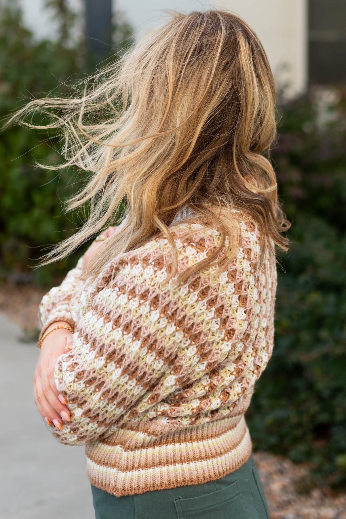 Side view of a khaki cardigan