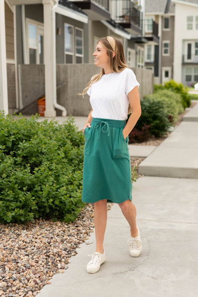 Side view of a teal skirt that ties at the waist