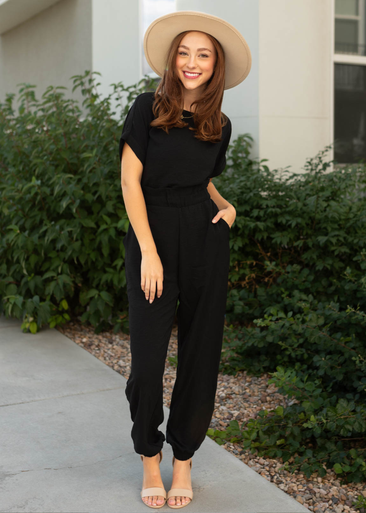 Black short sleeve jumpsuit with cuff at the ankle