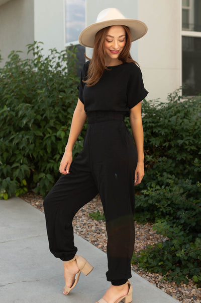 Short sleeve black jumpsuit with elastic band at the waist