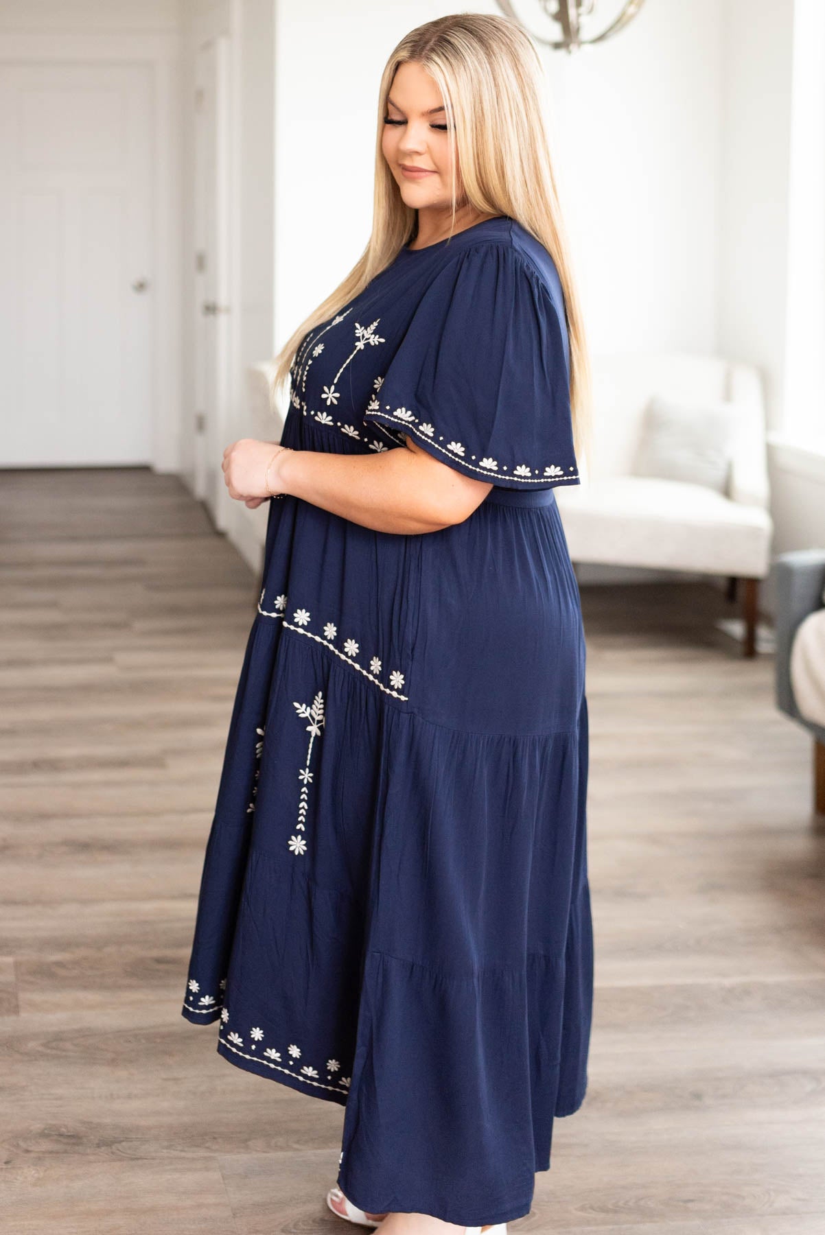 Side view of the plus size navy embroidered dress