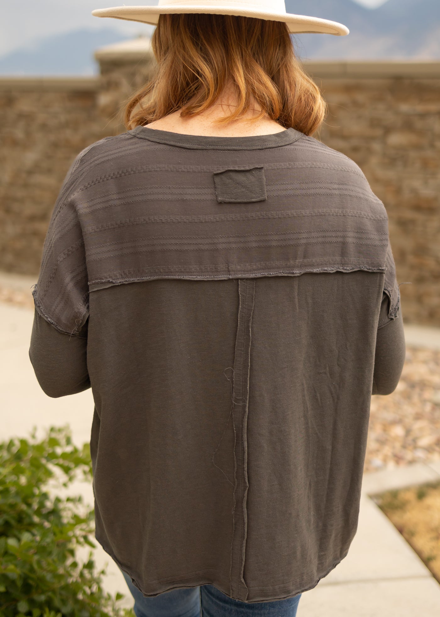 Back view of a charcoal top