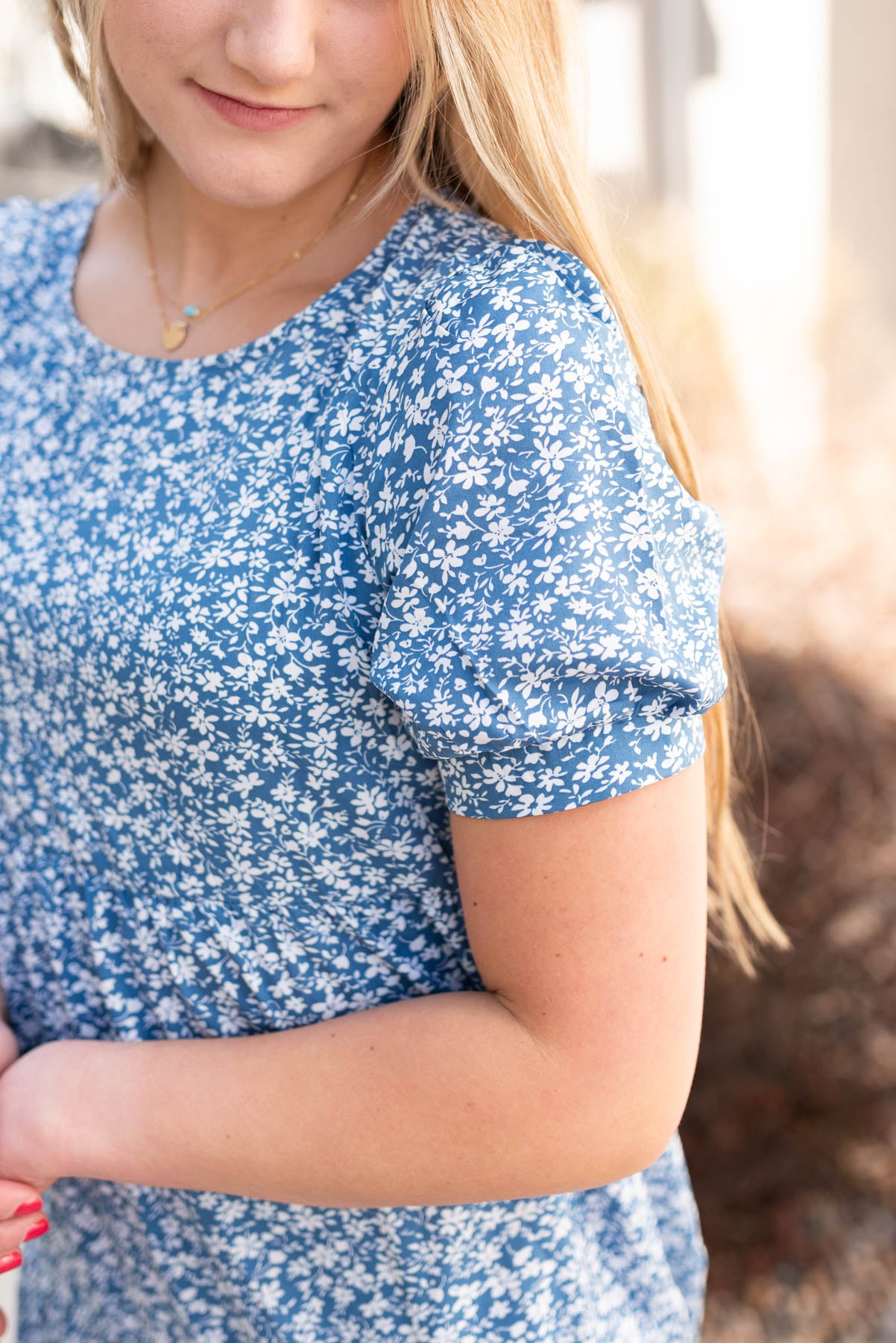 Close up of the sleeve and fabric on the navy floral dress