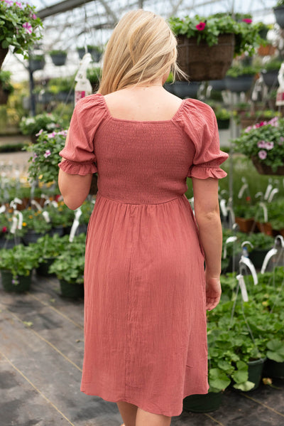 Back view of the dusty blush crocket smocked dress