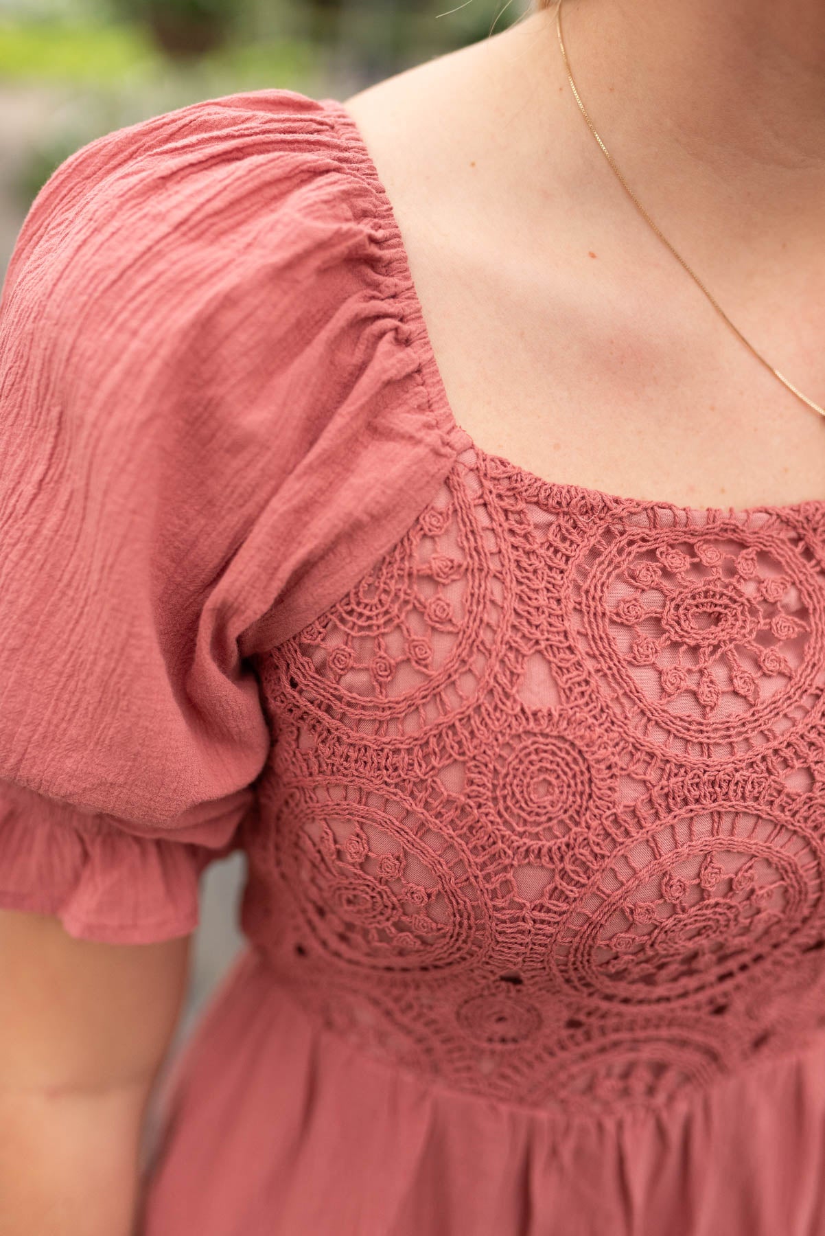 Close up of the crochet on the dusty blush crocket smocked dress