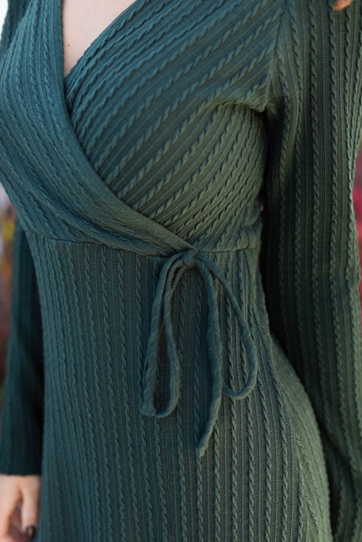 Close up of the waist of the hunter green textured maxi dress
