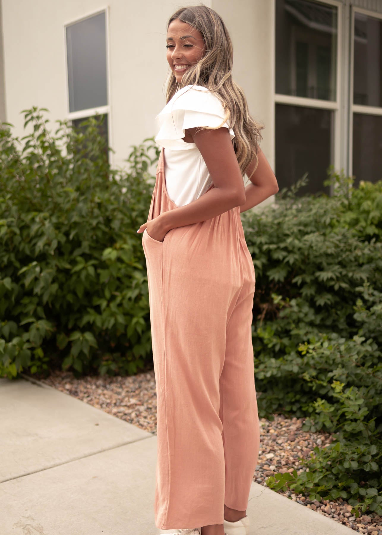 Side view of a clay jumpsuit