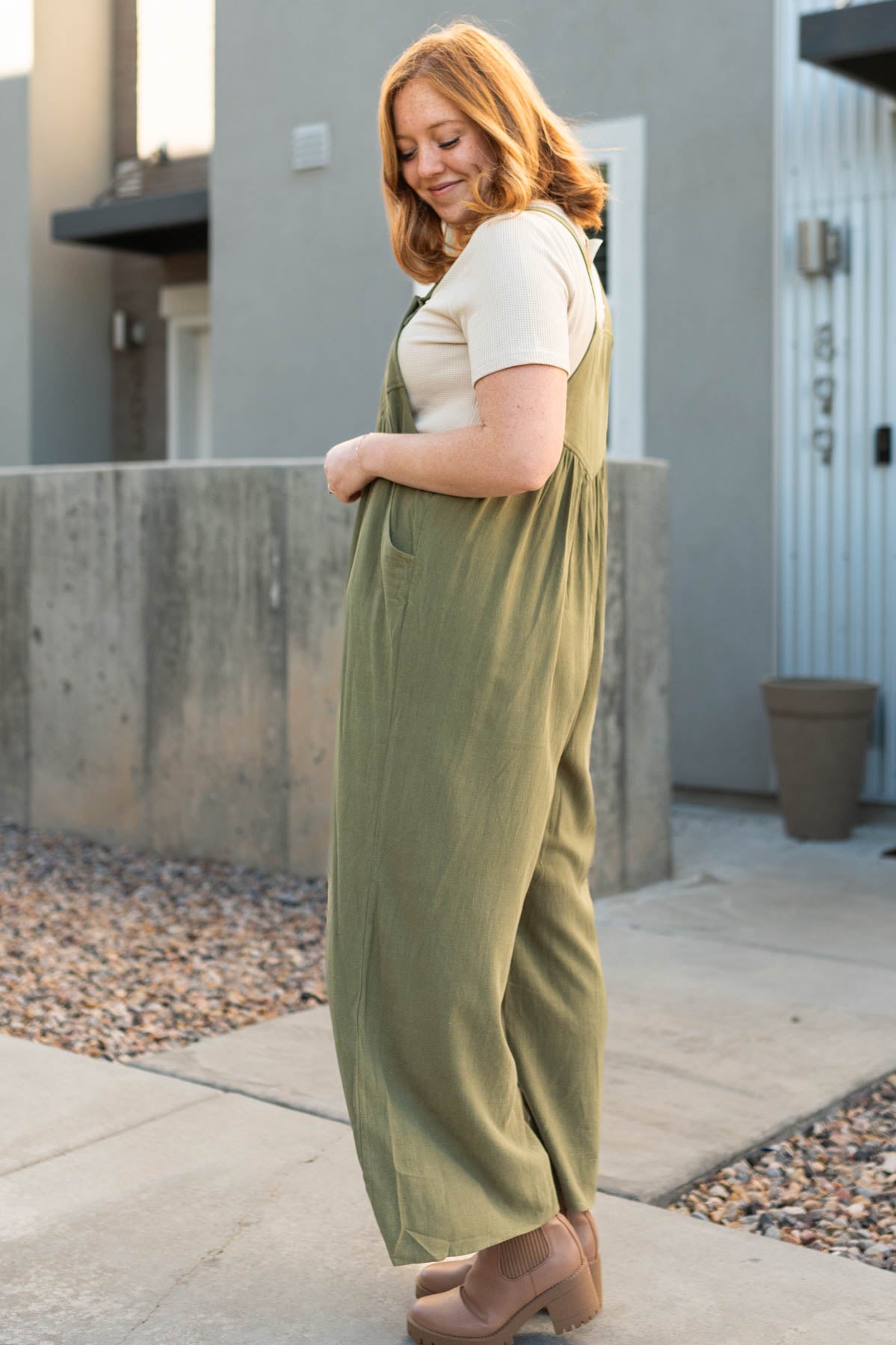 Side view of a olive jumpsuit