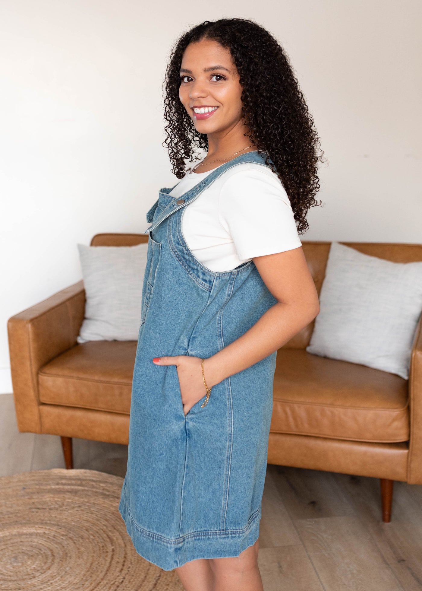 Side view of the washed denim overall dress