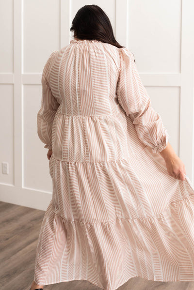 Back view of the plus size tan patterned dress