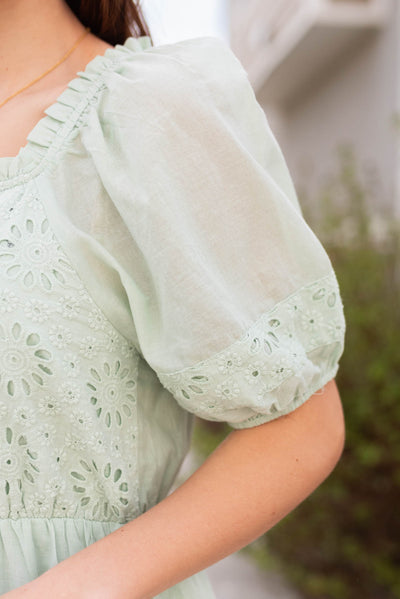 Close up of the sleeve and fabric on the sage eyelet tiered dress