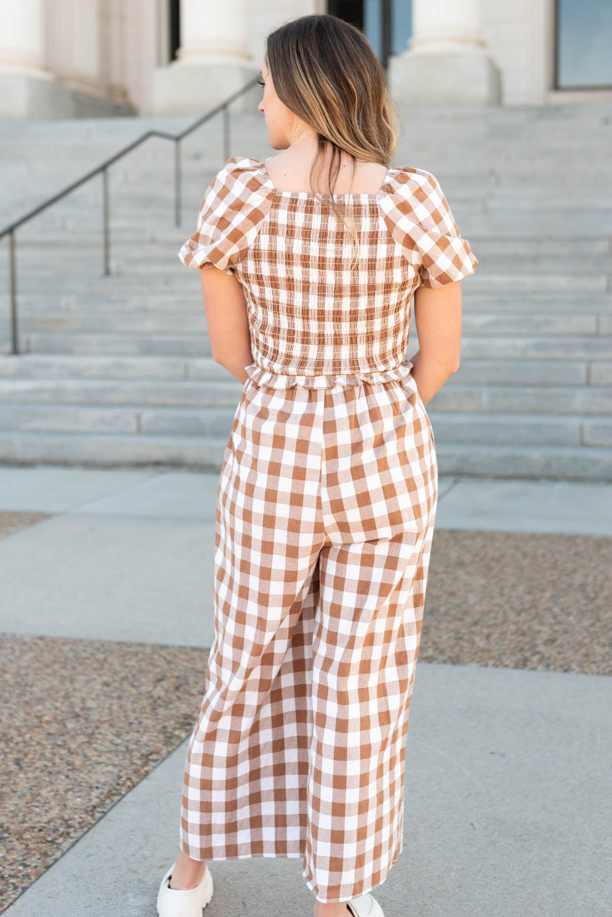Back view of the taupe gingham jumpsuit