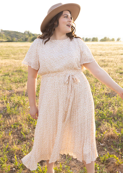 Plus size ivory floral dress with short sleeves and ties at the waist