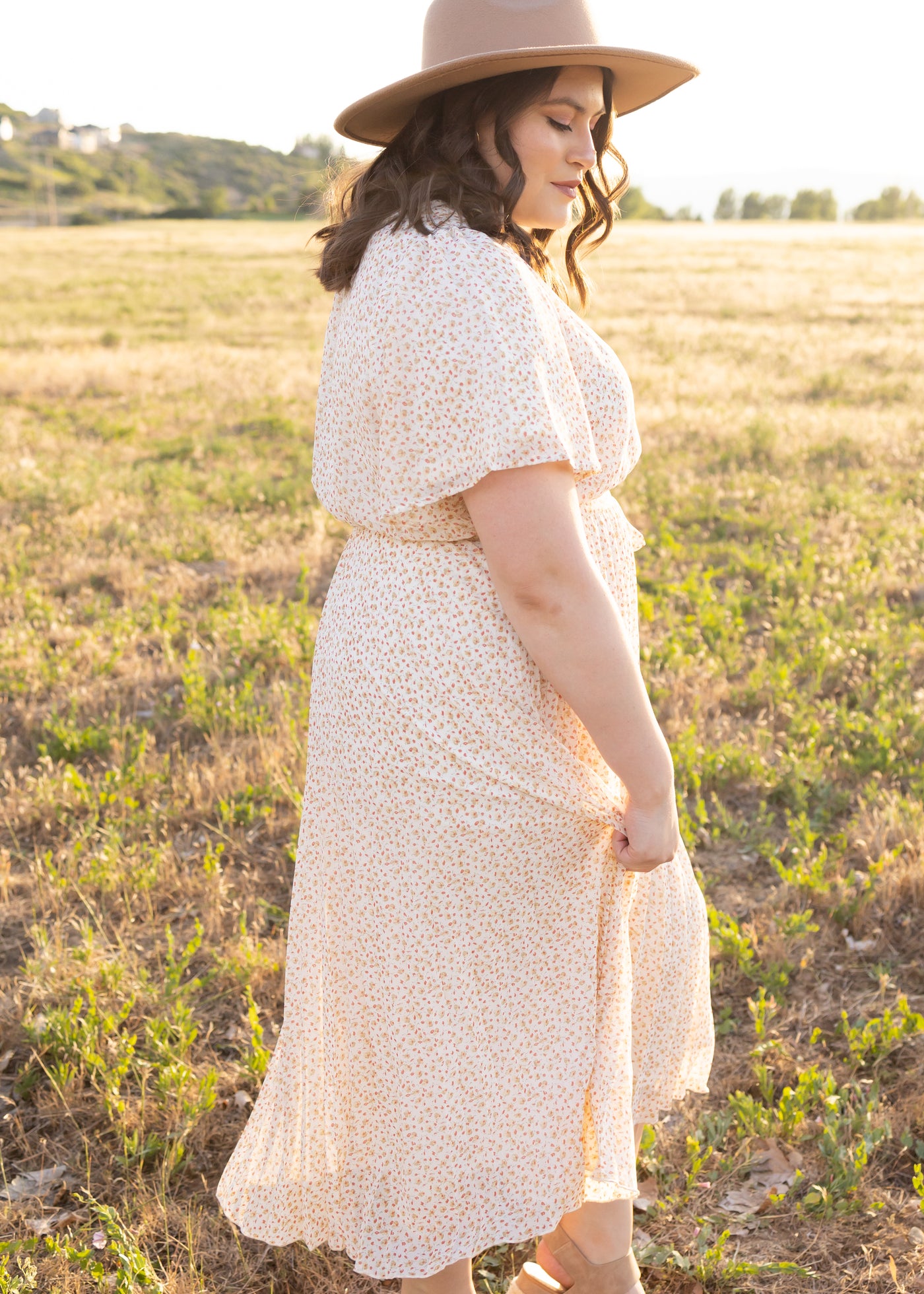 Side view of a plus size ivory floral dress