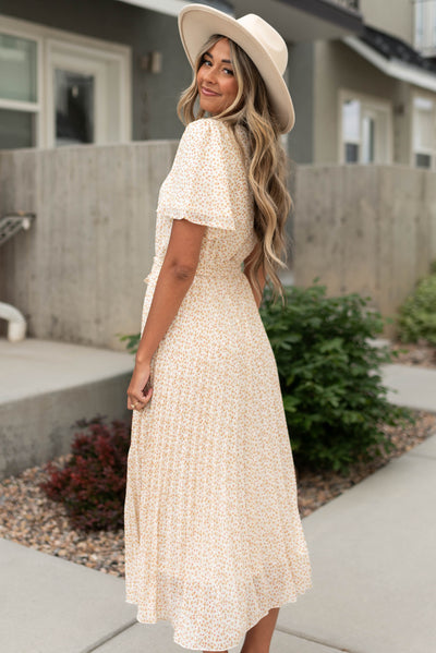 Side view of an ivory floral dress