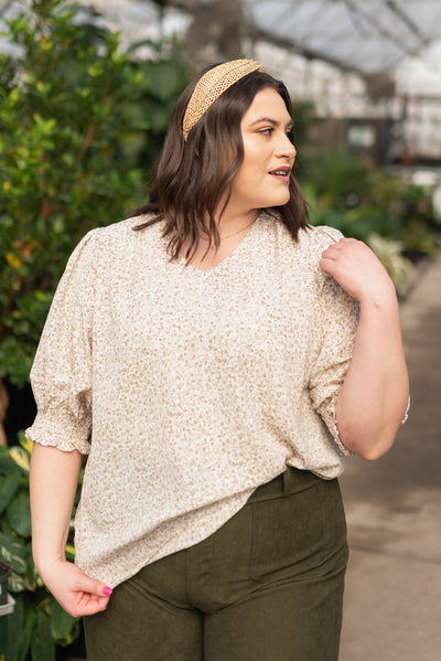 Plus size taupe floral print top with short sleeves and a v-neck