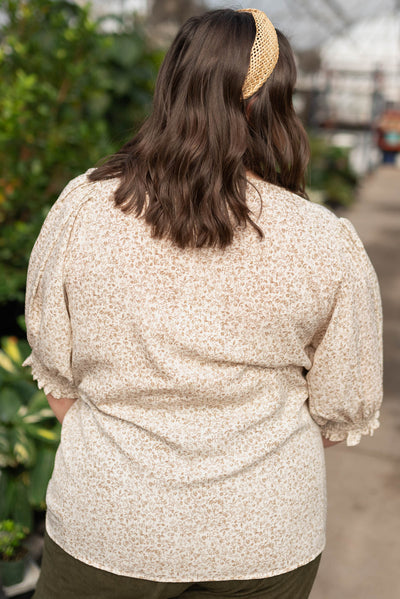 Back view of the plus size taupe floral print top