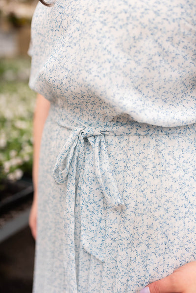 Close up of the fabric and pleats on the ivory blue floral pleated dress