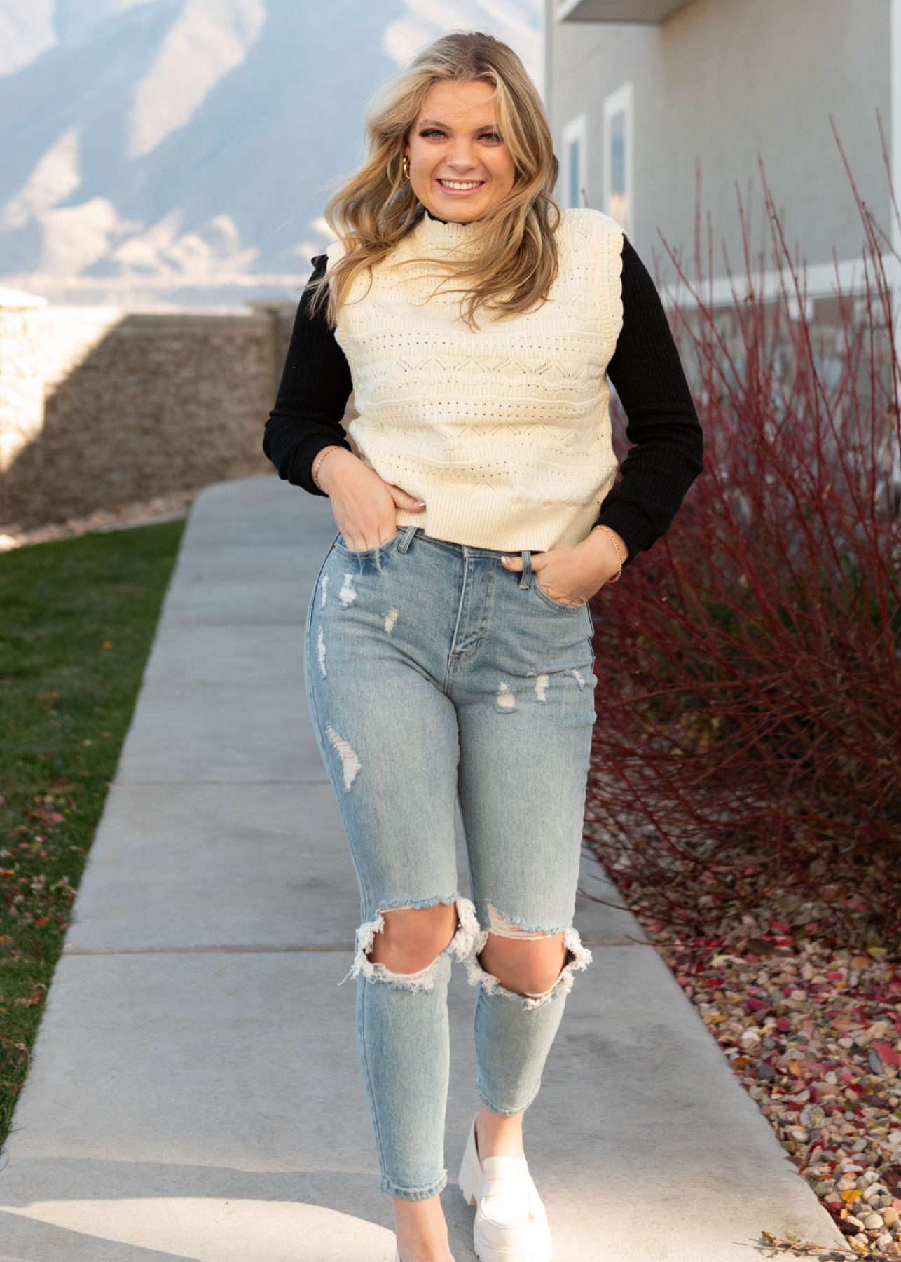 Front view of a ivory knit sweater vest