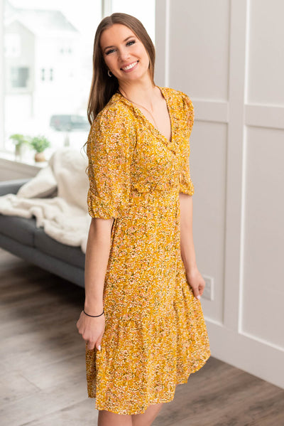 Side view of a mustard floral dress