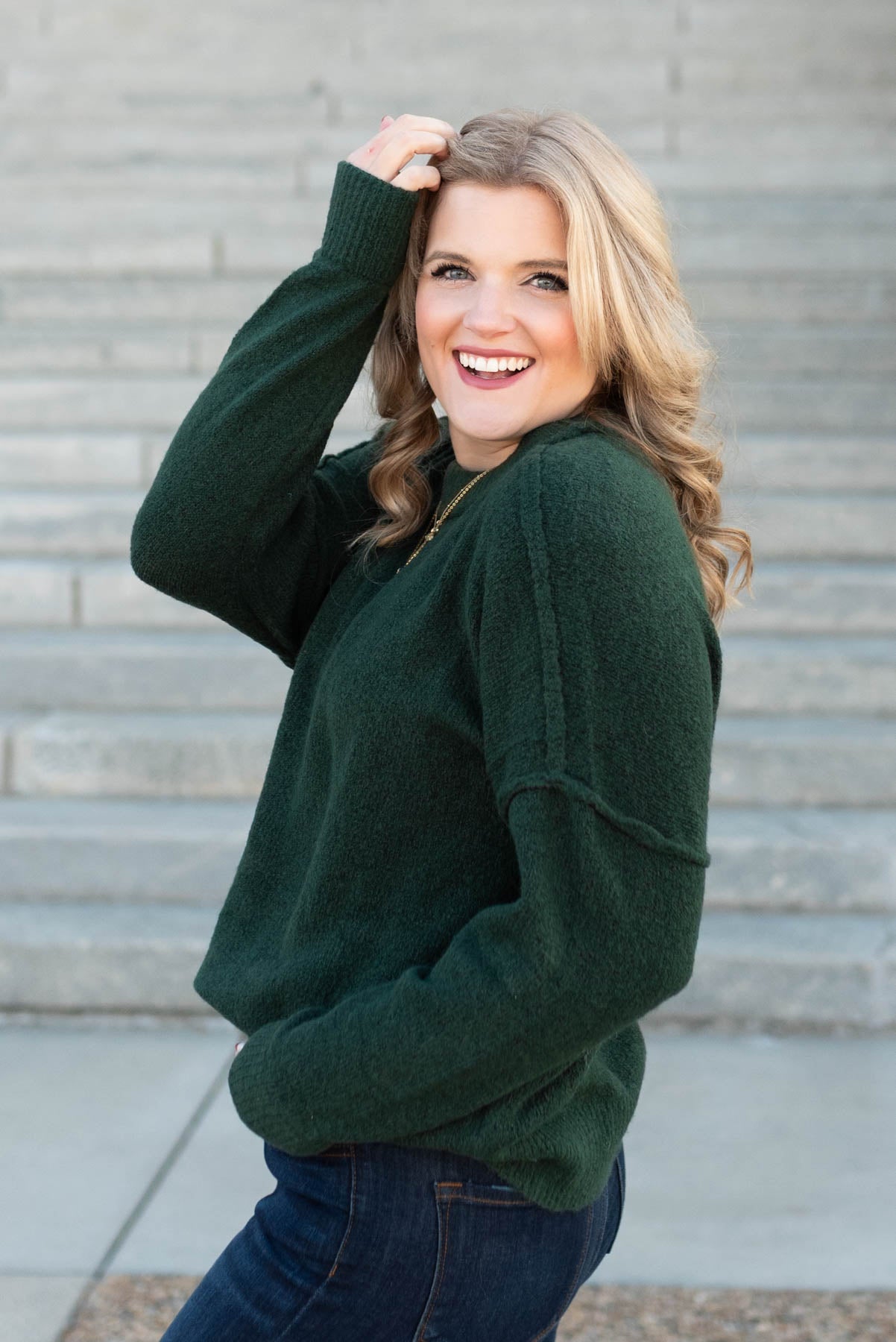 Side view of the hunter green knit pullover