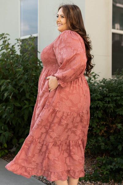 Side view of a plus size dusty rose dress with pockets