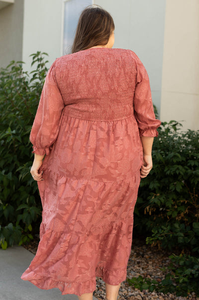 Back view of a plus size dusty rose dress with smocked bodice