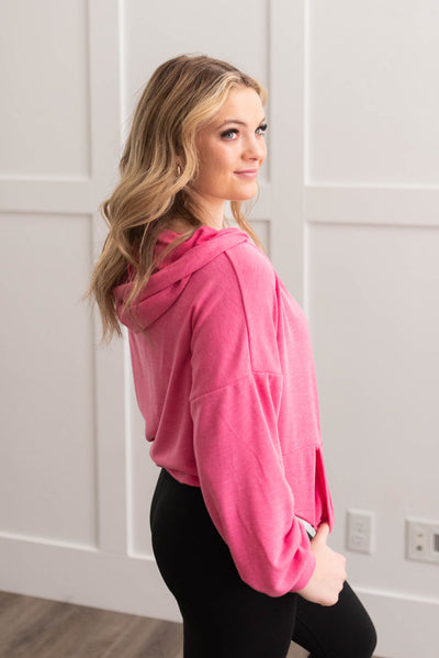 Side view of the hot pink half zip pullover