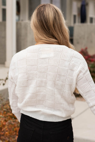 Back view of a white check knit pullover