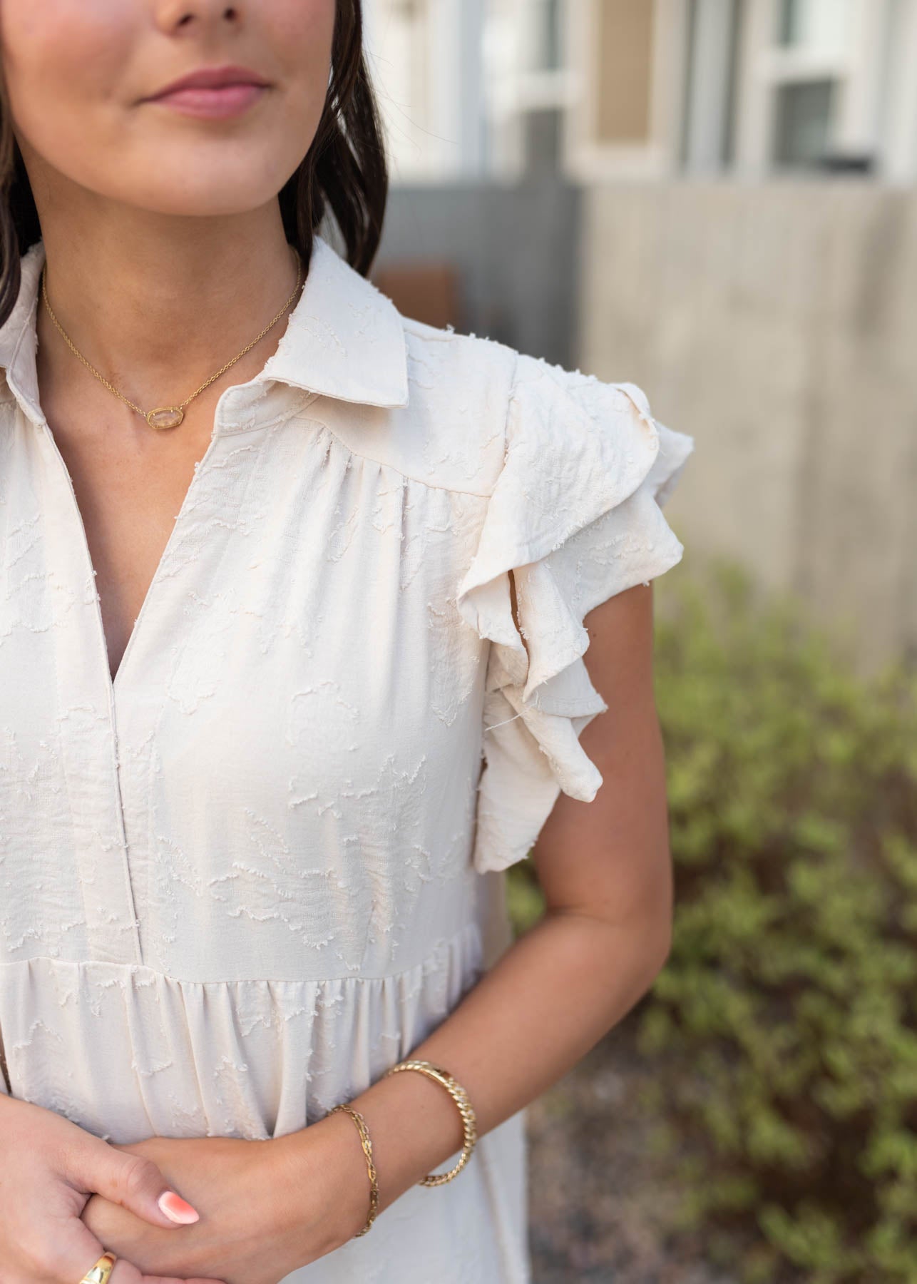 Close up of the sleeve and fabric on the natural flutter sleeve dress