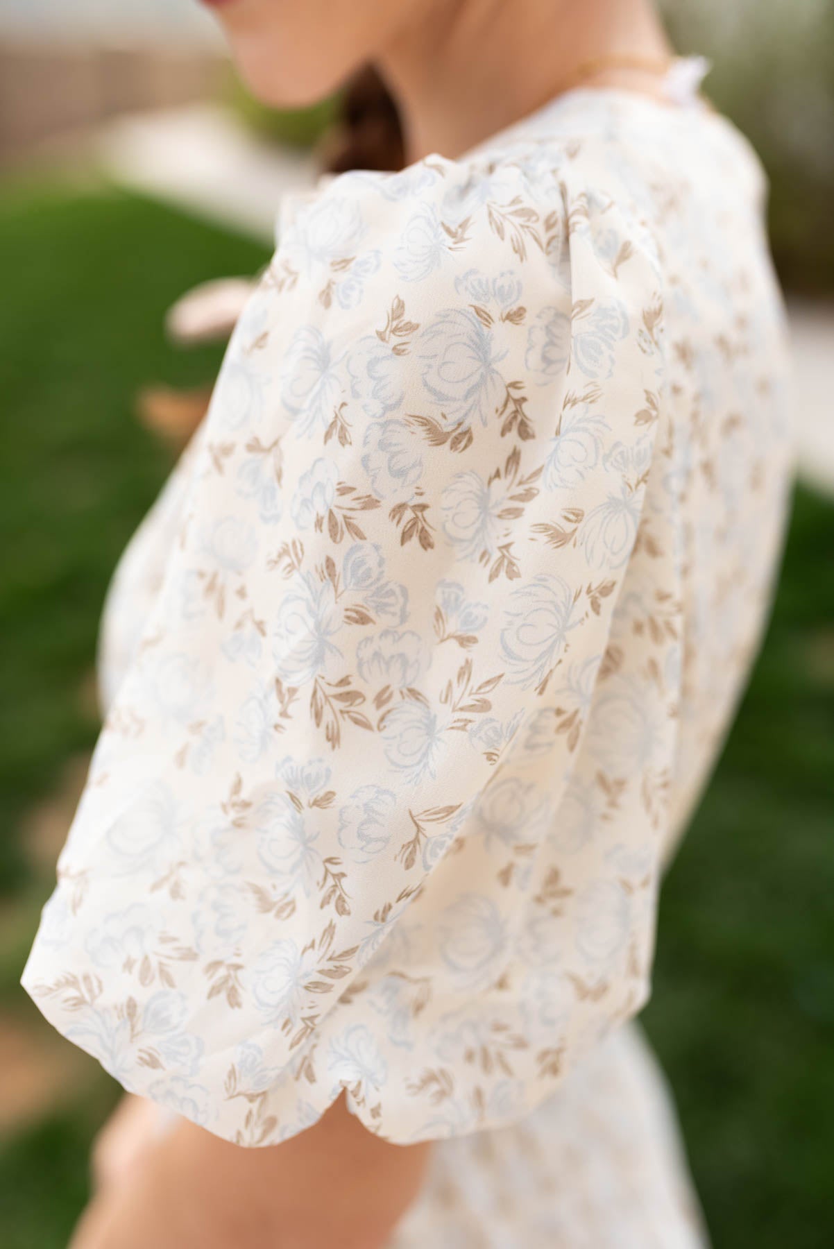 Close up of the sleeve and fabric on the dusty blue floral dress