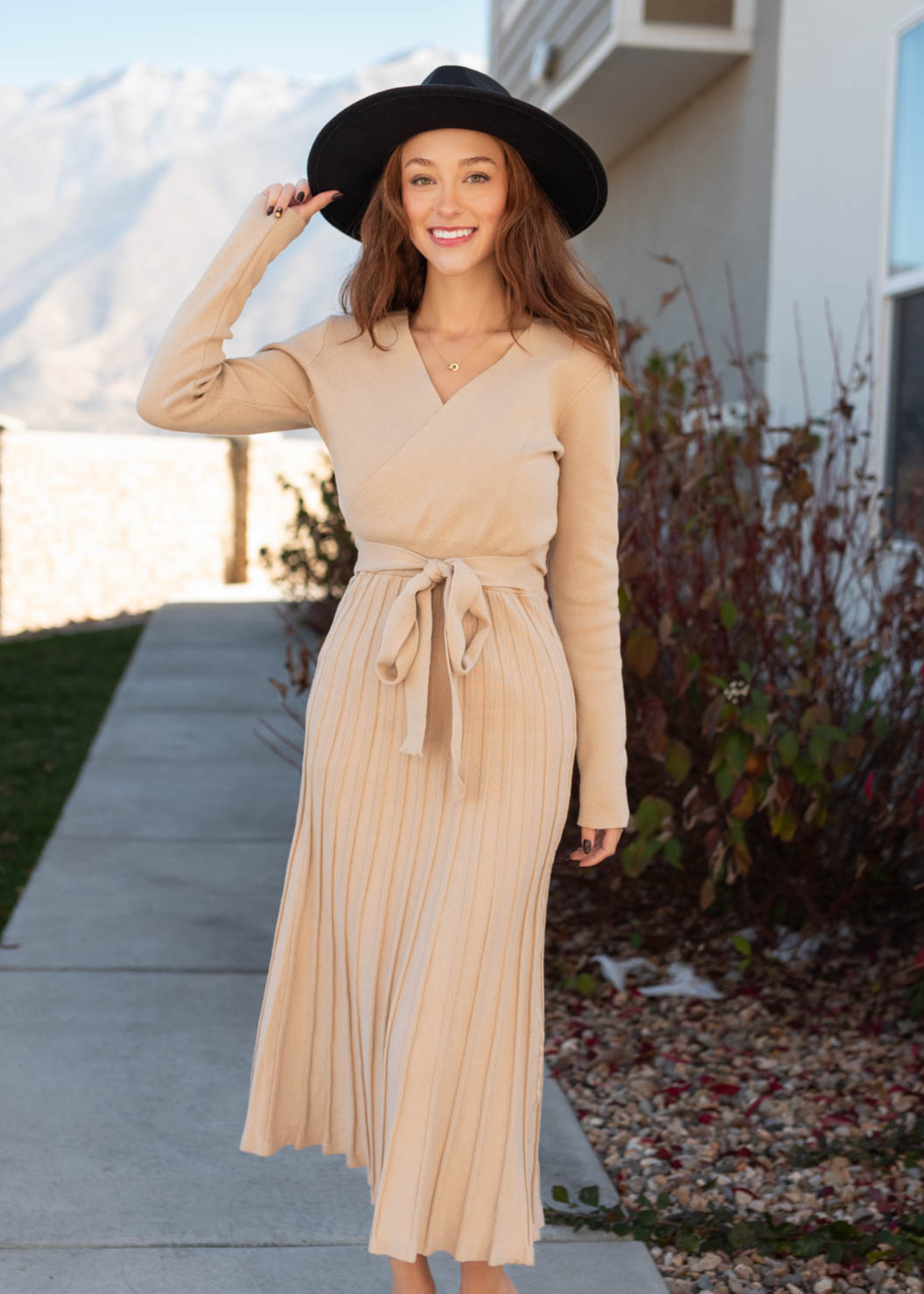 Nude sweater dress with pleated skirt