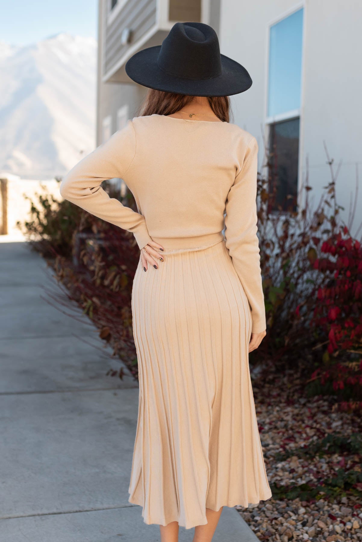 Back view of a nude sweater dress