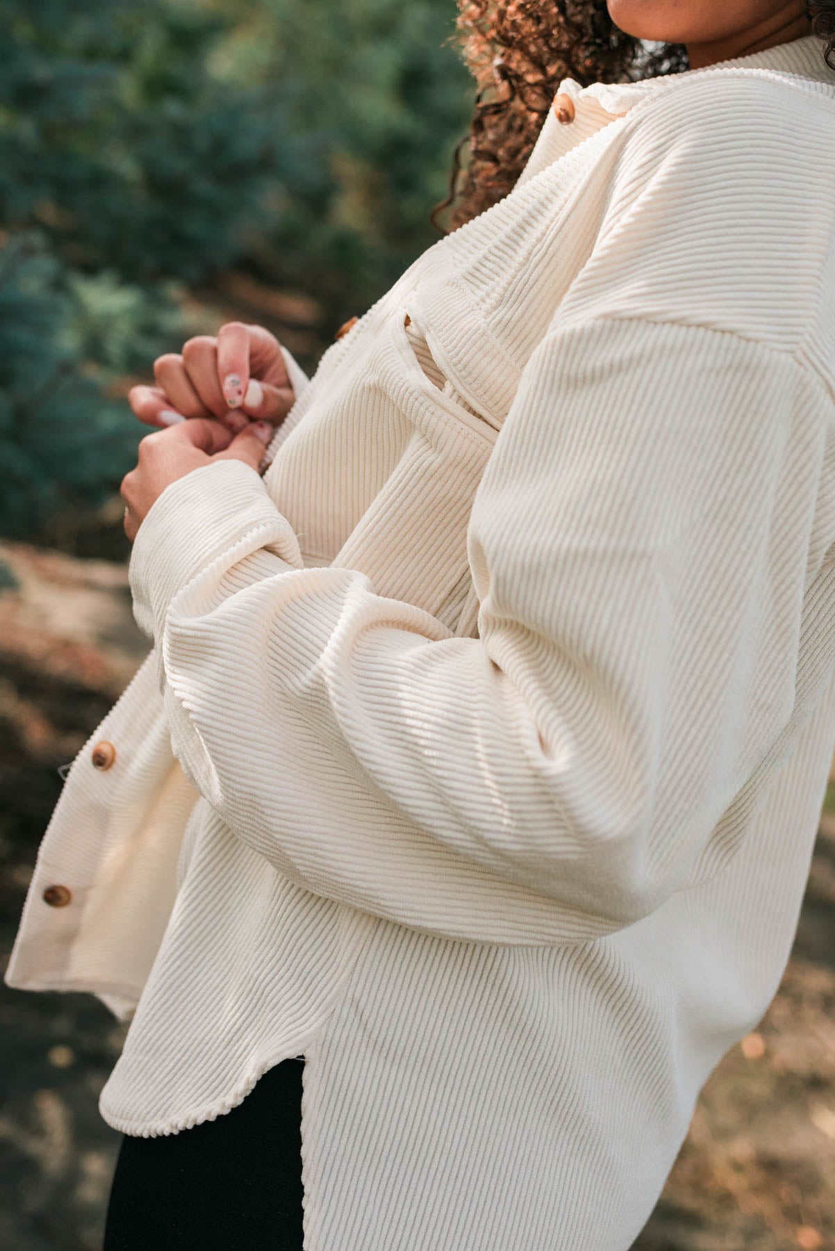 Side view of the oatmeal corduroy shacket with front pockets