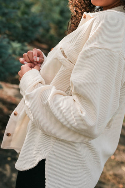 Side view of the oatmeal corduroy shacket with front pockets
