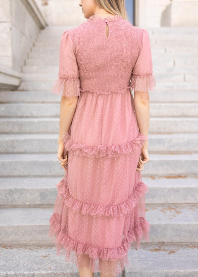 Back vie of a short sleeve dusty pink dress with ruffle skirt