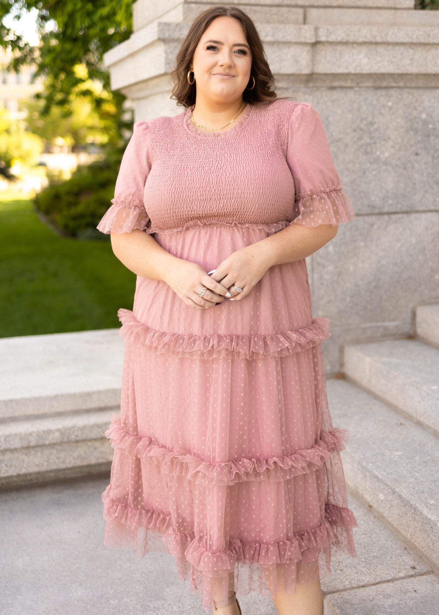 Plus size dusty pink dress with short sleeves and smocked bodice