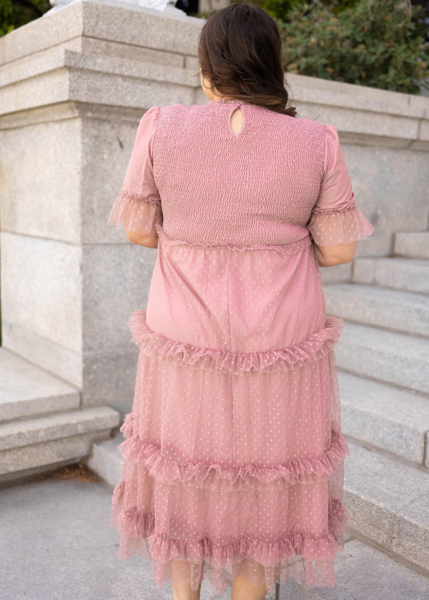 Back view of a plus size dusty pink dress with short sleeves