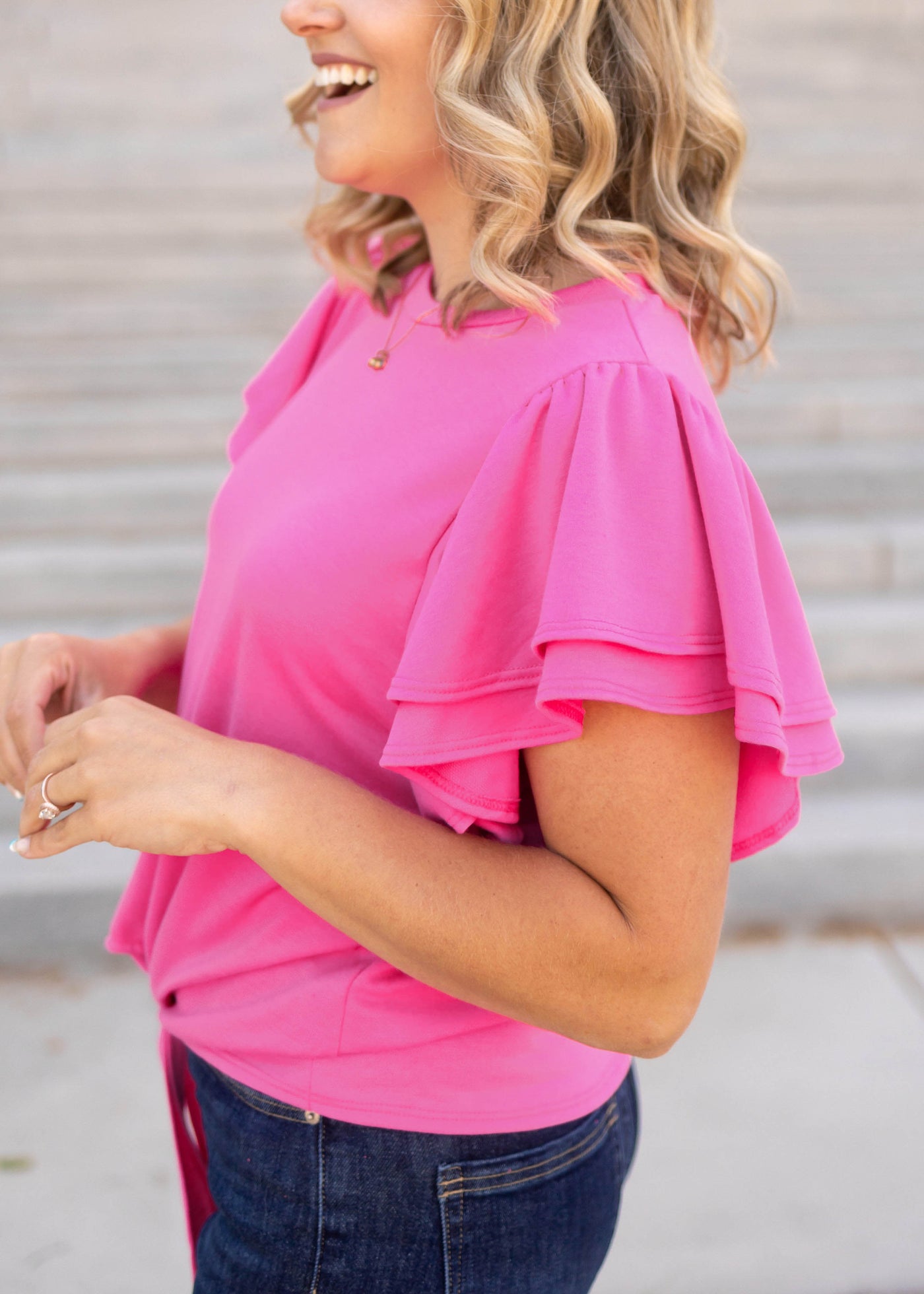 Side view of a short sleeve hot pink top