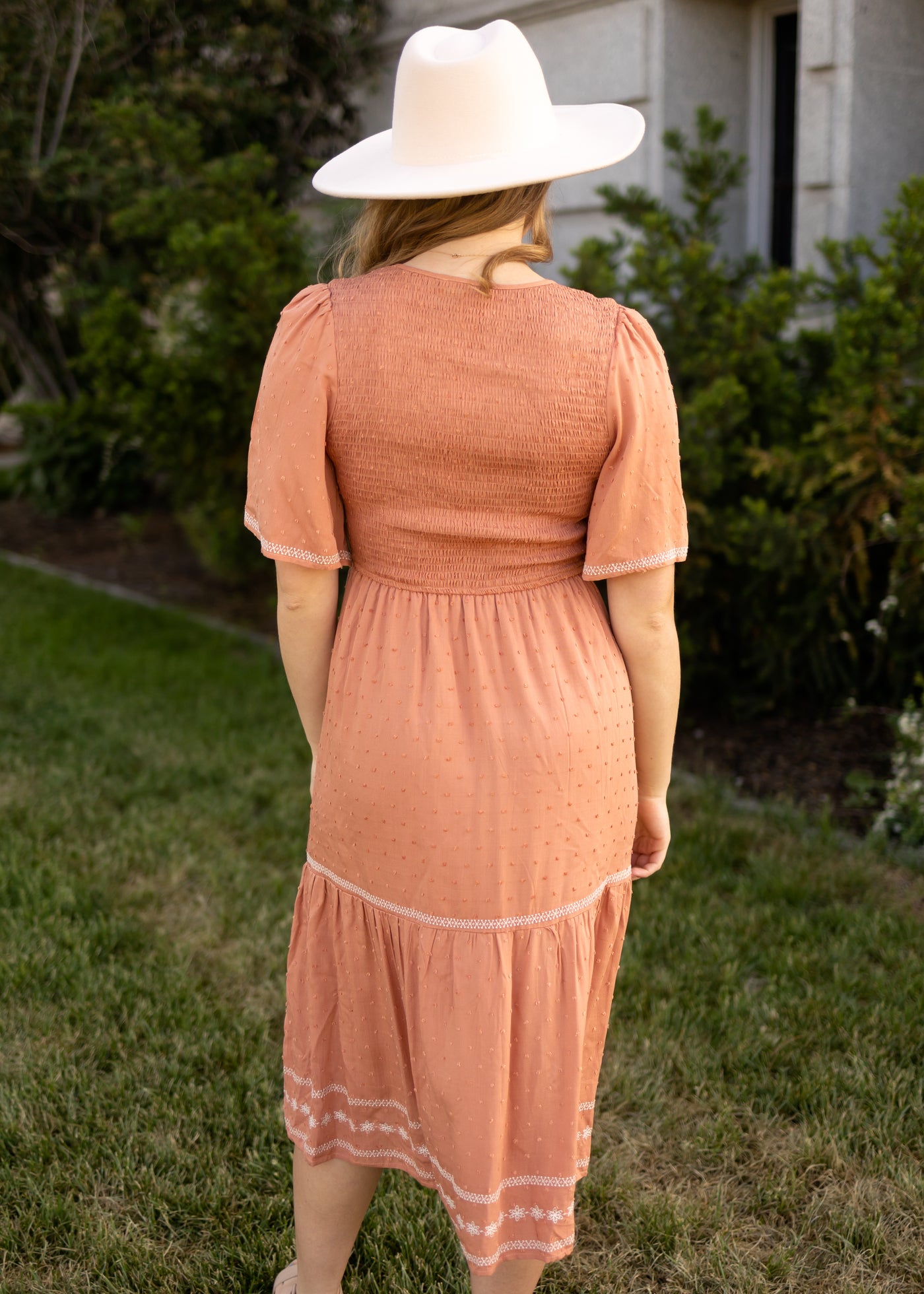Back view of a short sleeve terracotta dress