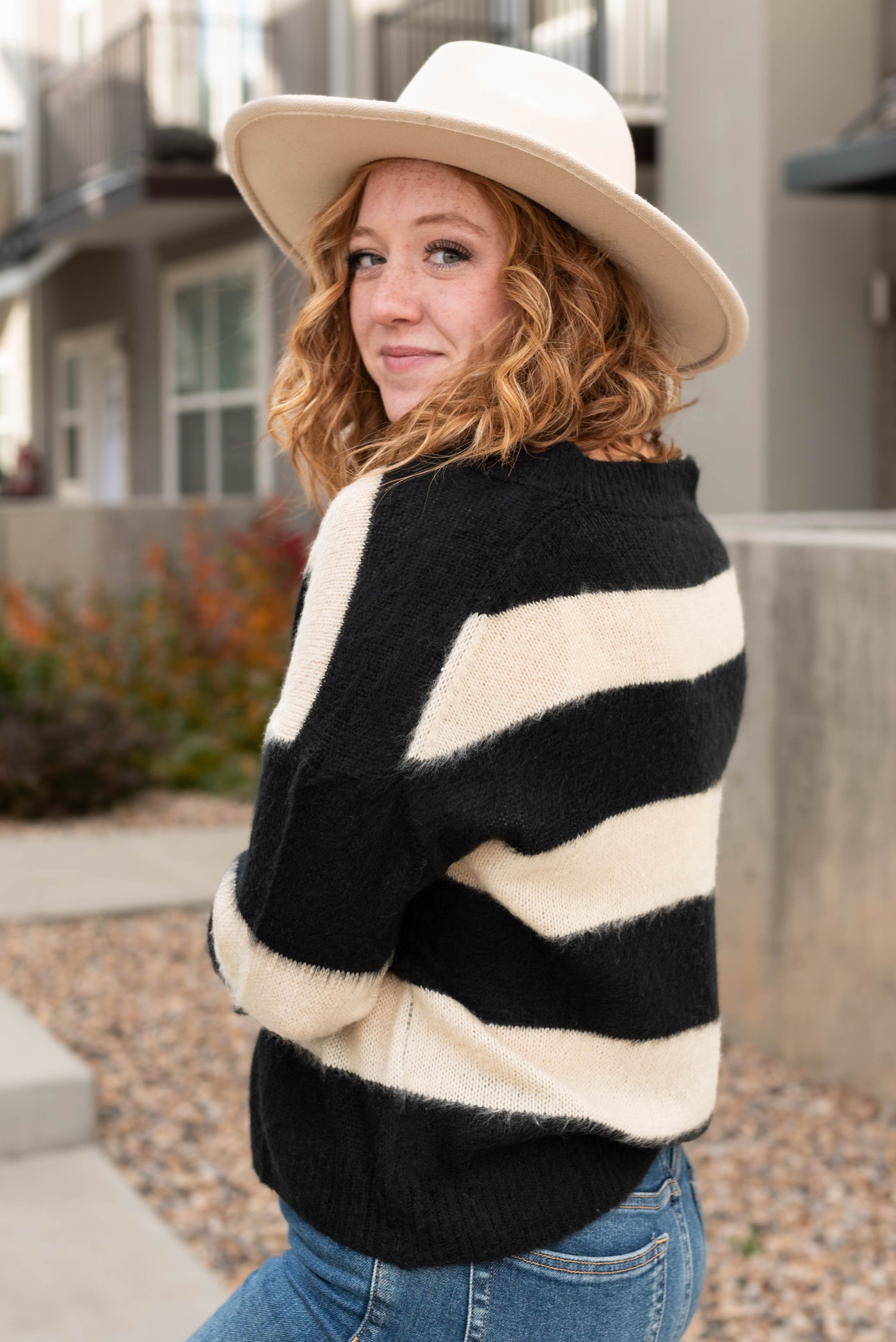 Side view of a striped black sweater
