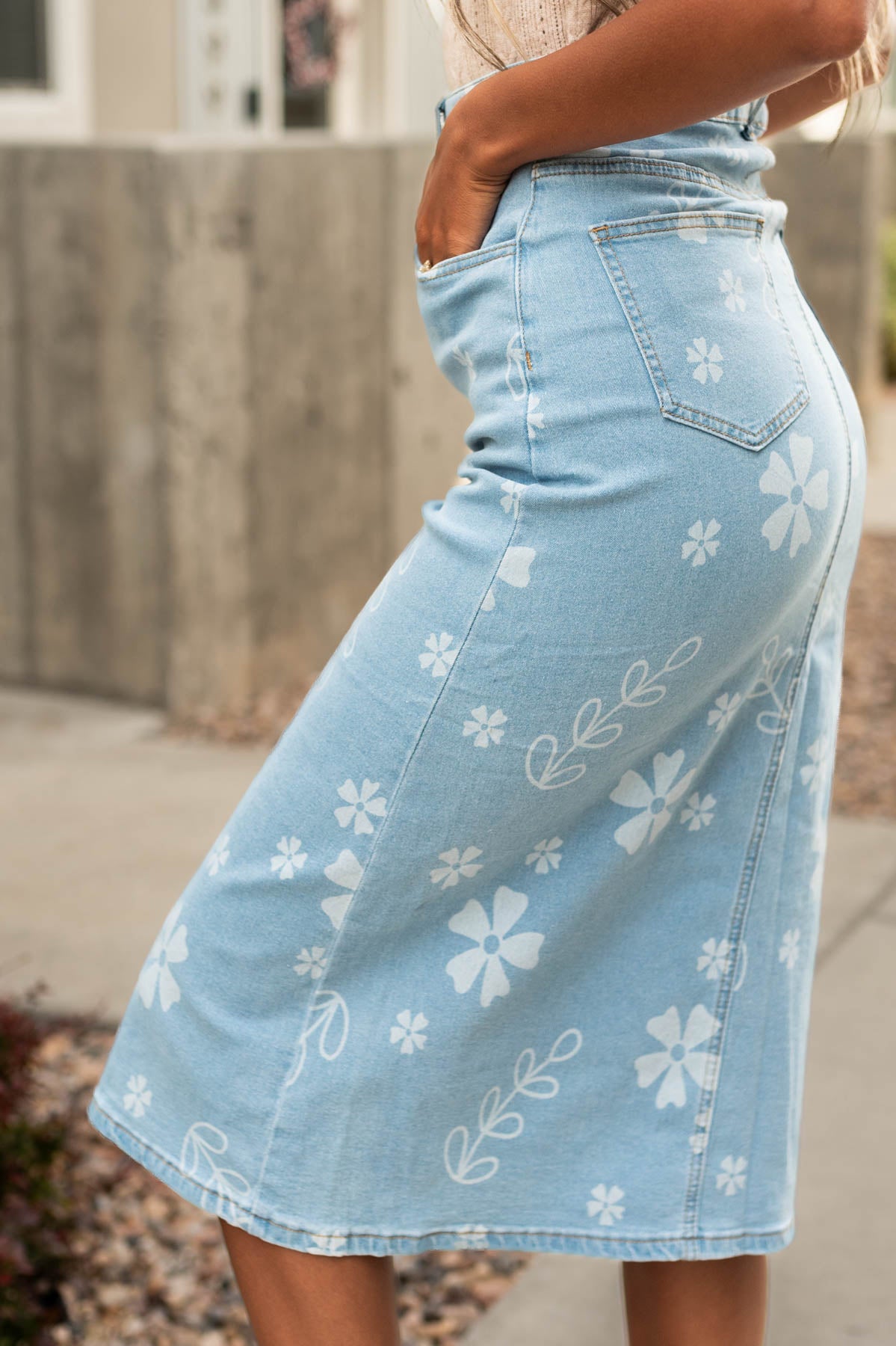 Side view of a denim skirt with white flowers