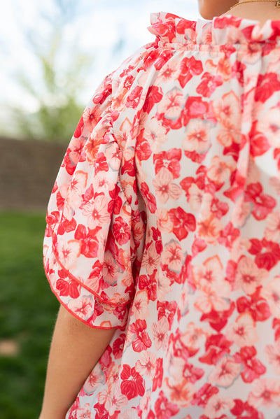 Close up of the sleeve and fabric on the pink floral ruffle blouse