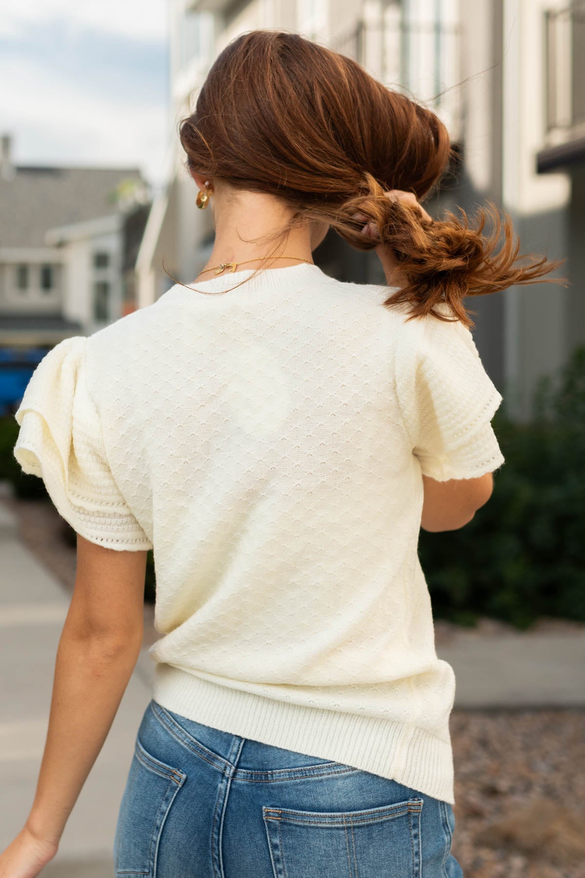 Back view of a ivory sweater top