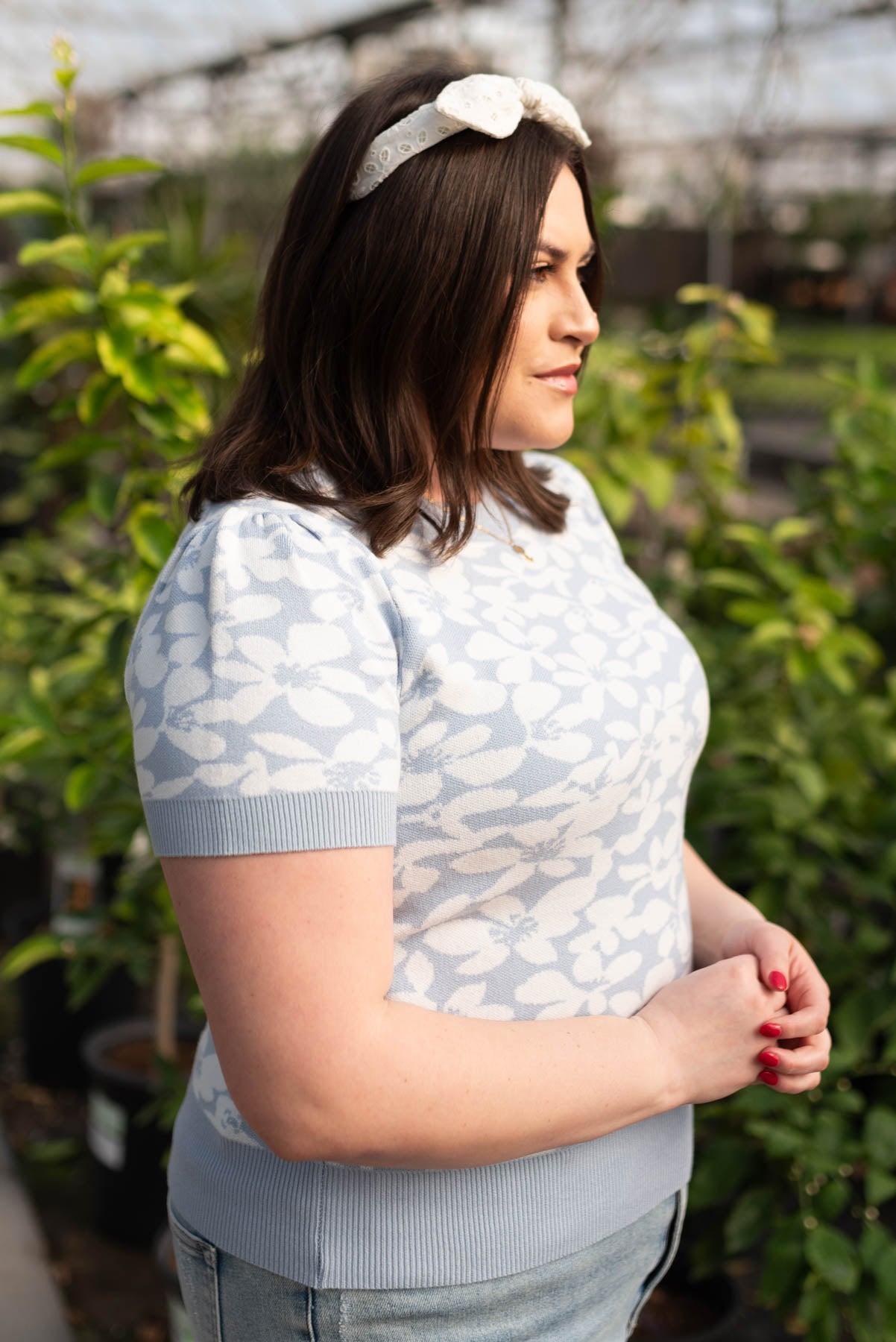 Side view of the plus size blue floral knit top