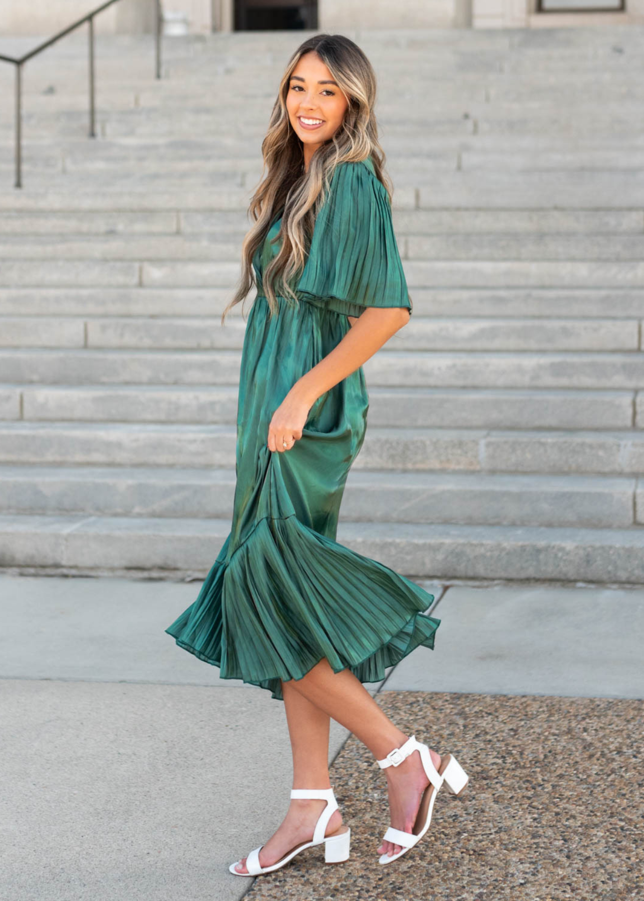 Side view of the hunter green pleated wrap dress