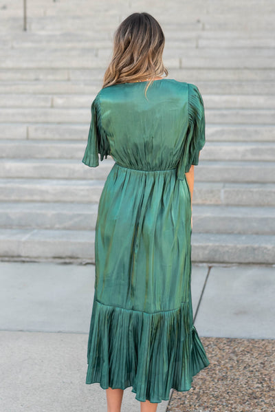 Back view of the hunter green pleated wrap dress