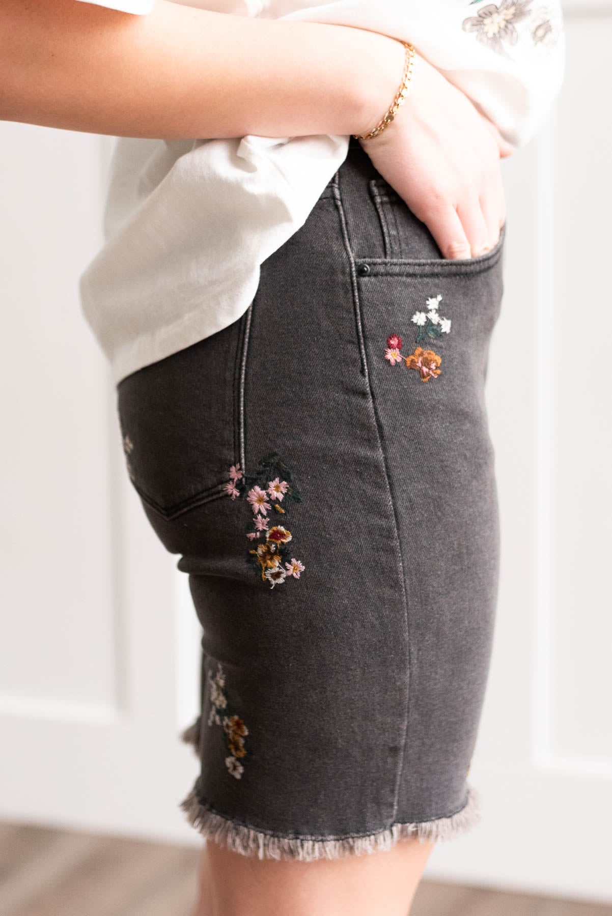 Side view of the the black floral embroidered shorts